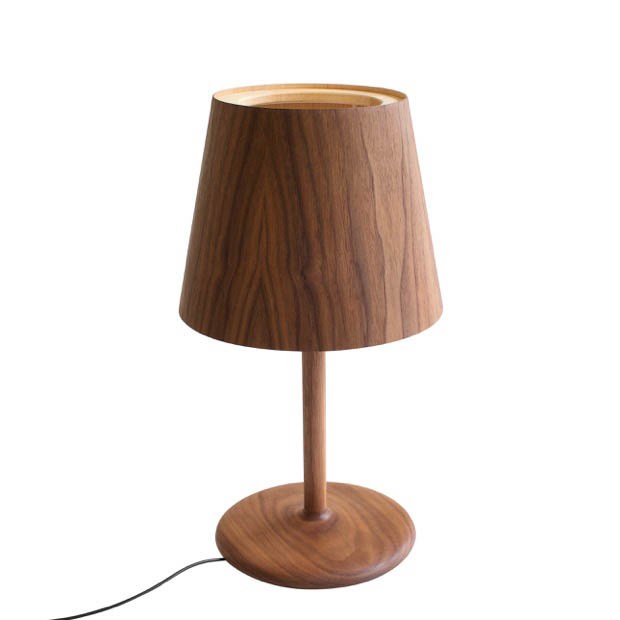 Walnut table lamp by Pierre + Charlotte with tapered shade and round base.