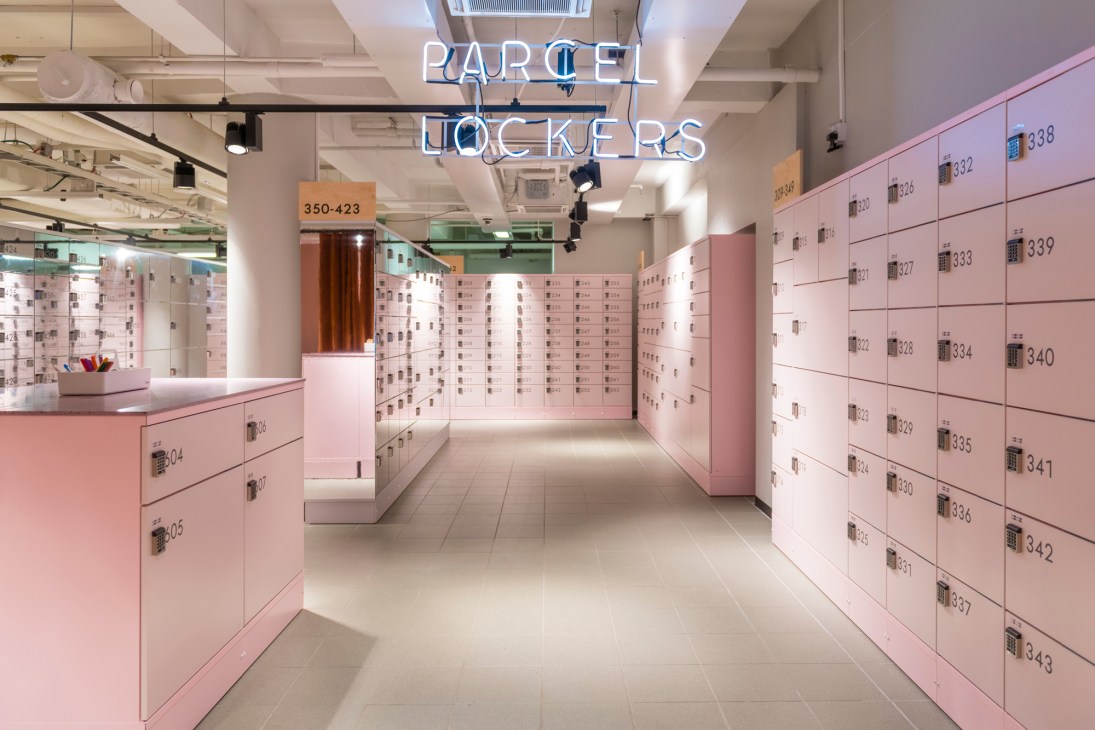Pink parcel lockers with numbered compartments at Box by Posti, Finland's innovative postal service hub.