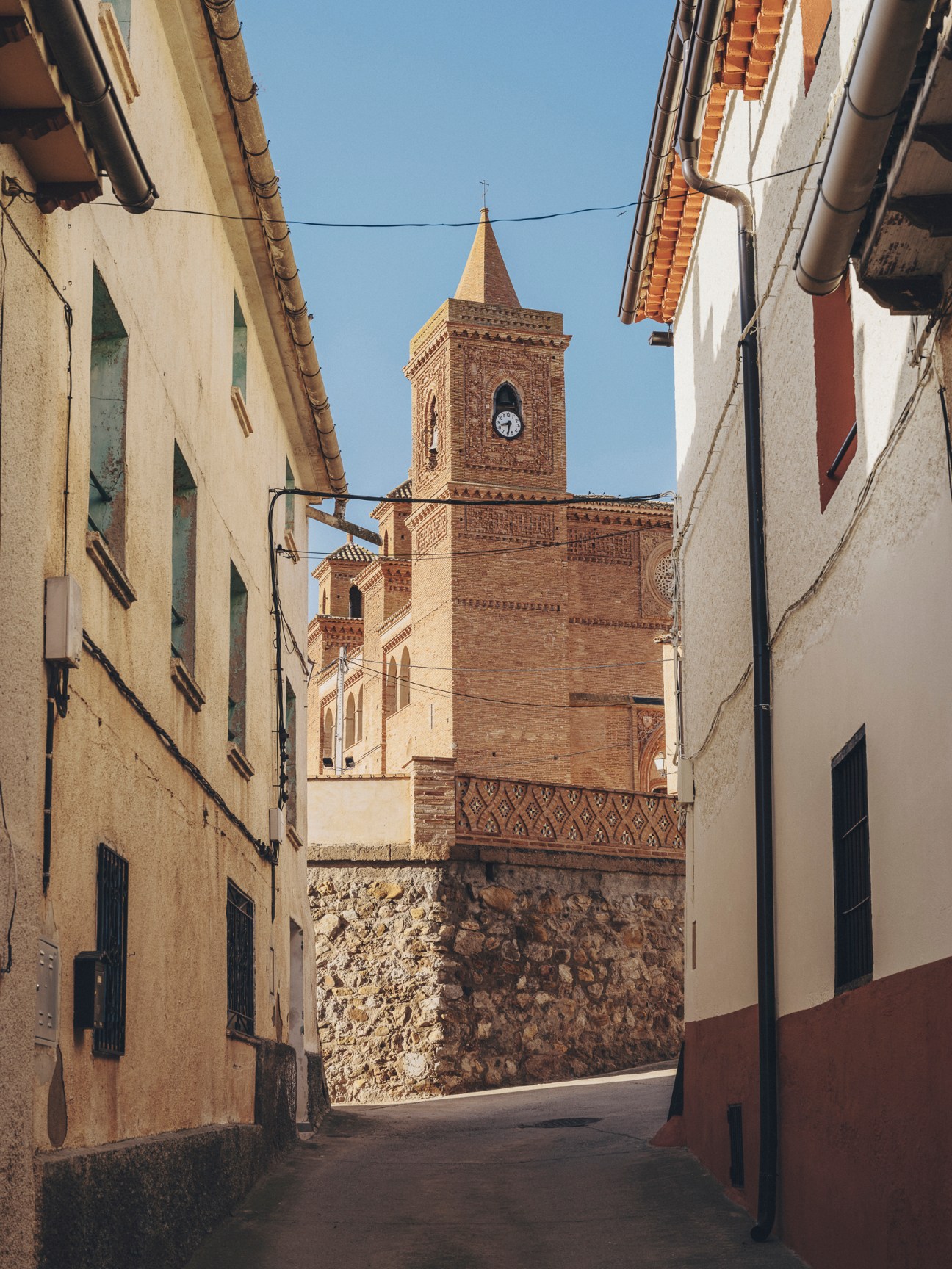 Panoramic view of Torralba de Ribota village with traditional buildings and church bell tower in rural Aragón