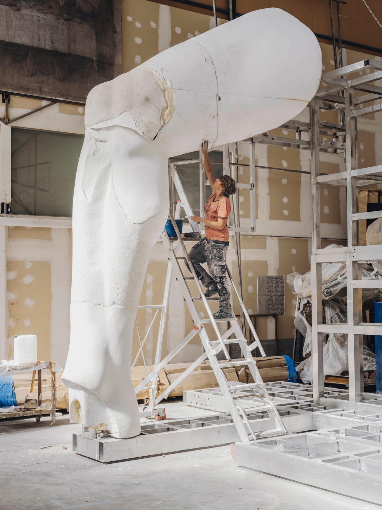 Craftsperson carefully polishing and finishing the surface of the reconstructed Colossus of Constantine at Factum Arte workshop
