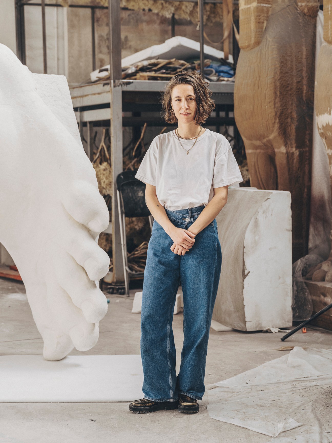 Irene Gaumé, 3D sculptor at Factum Arte, standing in workshop surrounded by white sculptural works