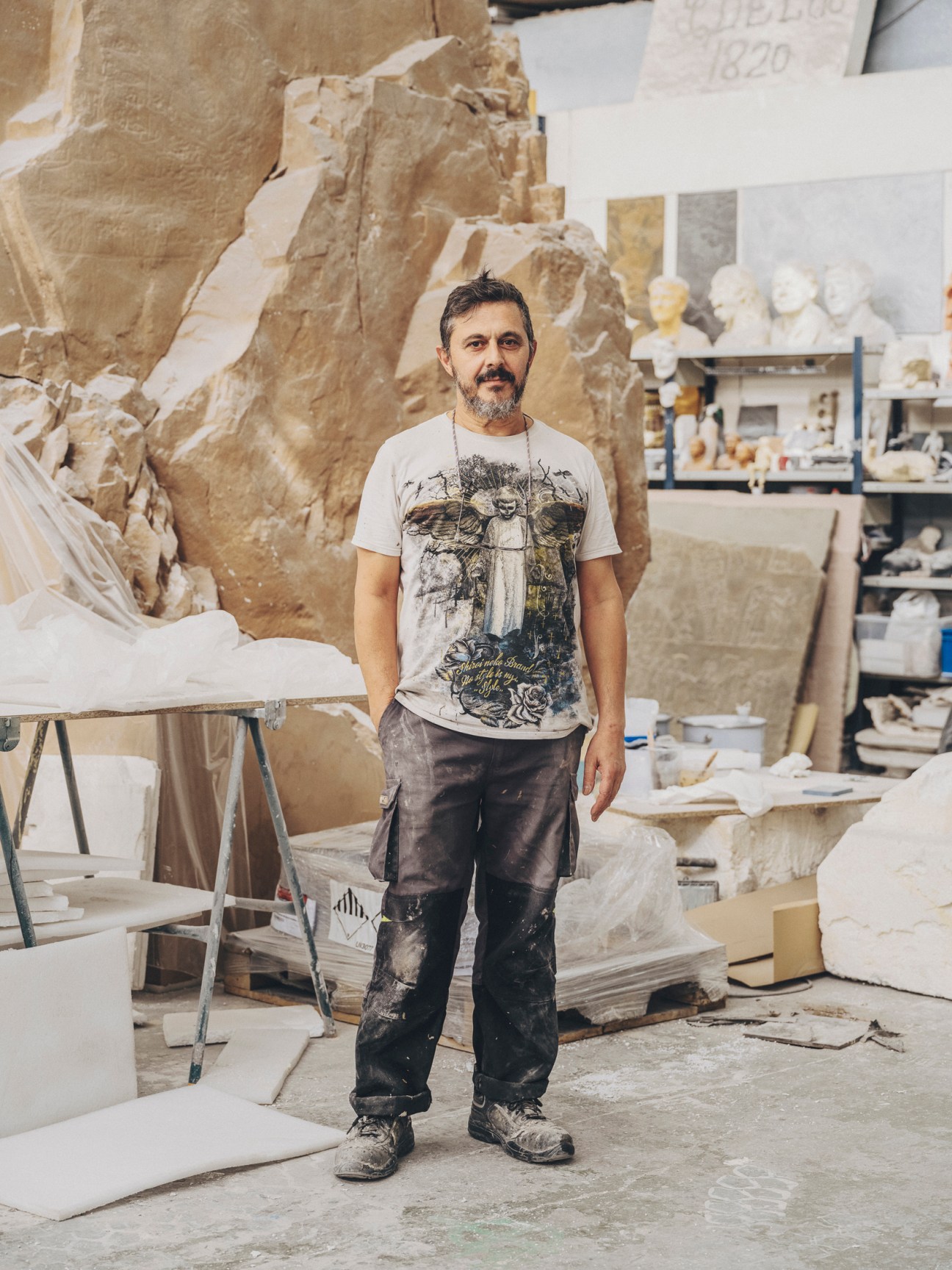 Juan Carlos Arías, workshop lead at Factum Arte, standing in the Madrid workshop surrounded by stone sculptures
