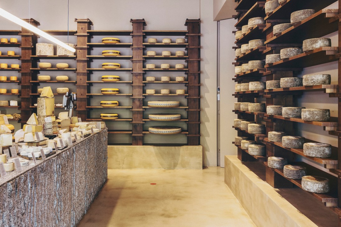 Close-up view of artisanal cheese selection at Formaje counter