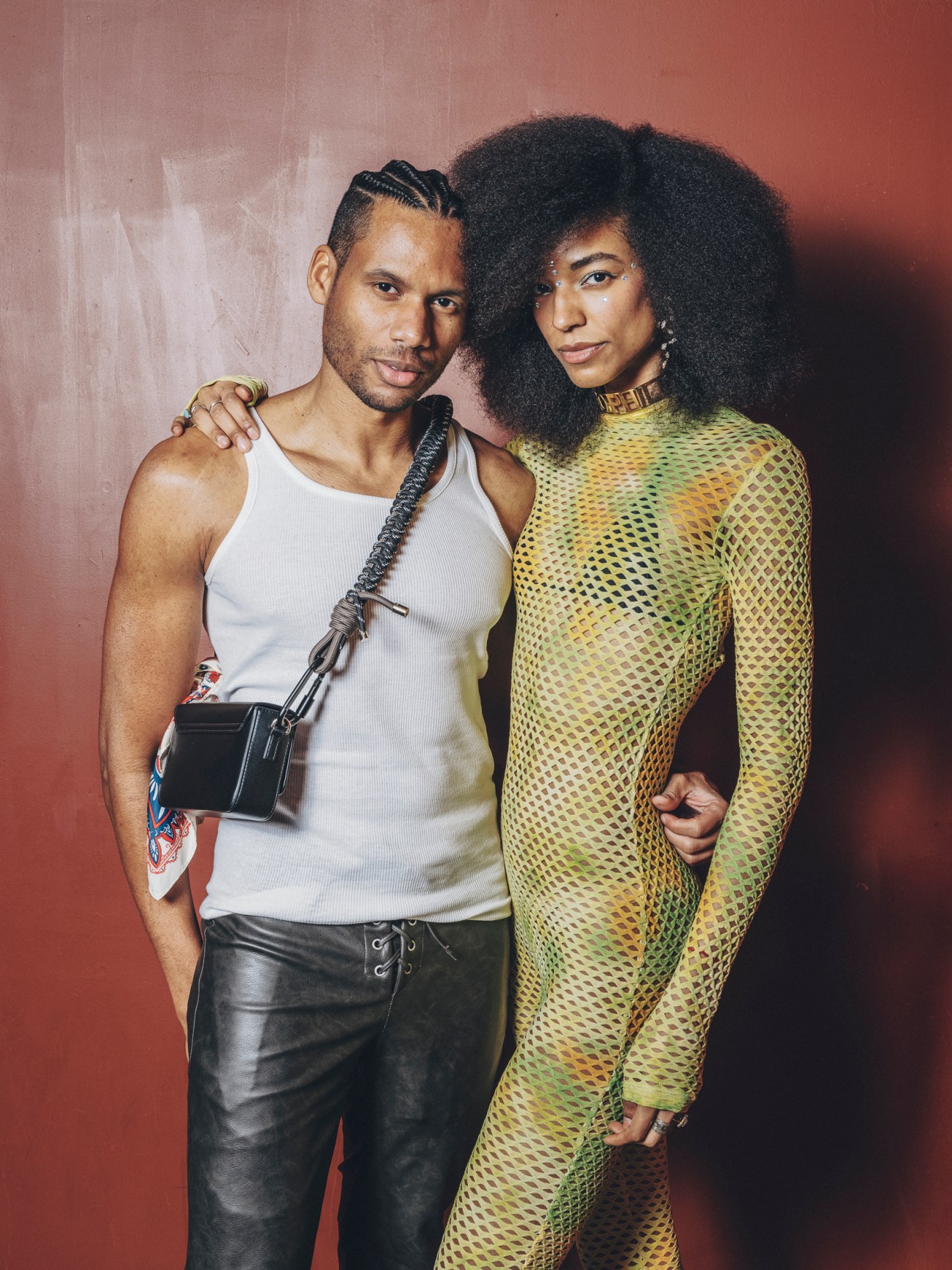 Dominican photographer Alejandro Brito and model Marianne Garces posing together at carnival party