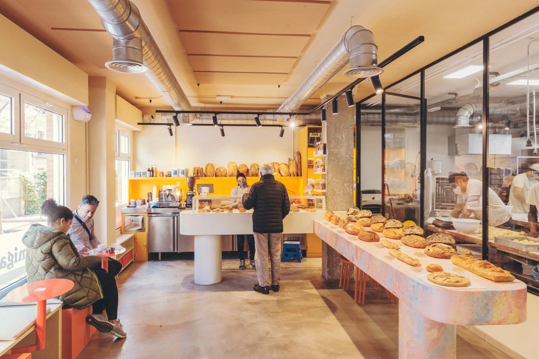 Interior view of Madreamiga bakery showing display counter and shelving with baked goods