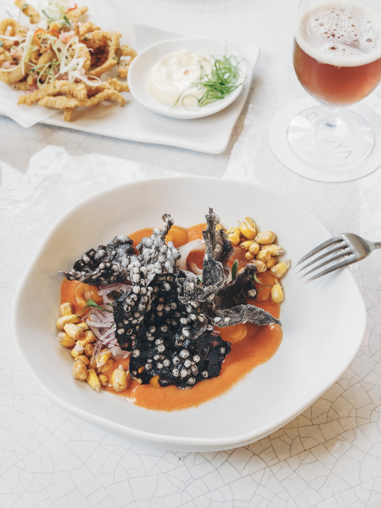 Gourmet dish with dark sauce and garnishes served at Restaurant Jerónimo at The Madrid Edition