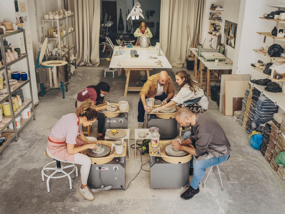 Roberto Paparcone instructing students at pottery wheels in his ceramics studio in Mallorca