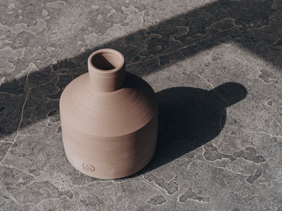 Finished ceramic pot with Paparkone brand stamp on natural stone surface