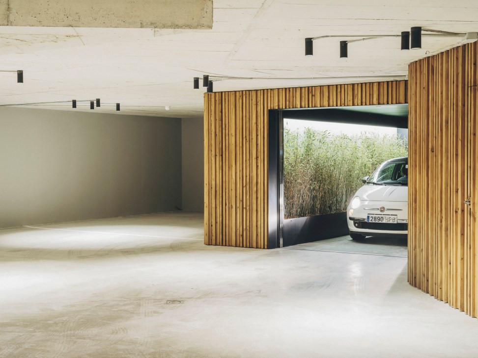 Car lift built by Malift with wooden slat walls in underground garage