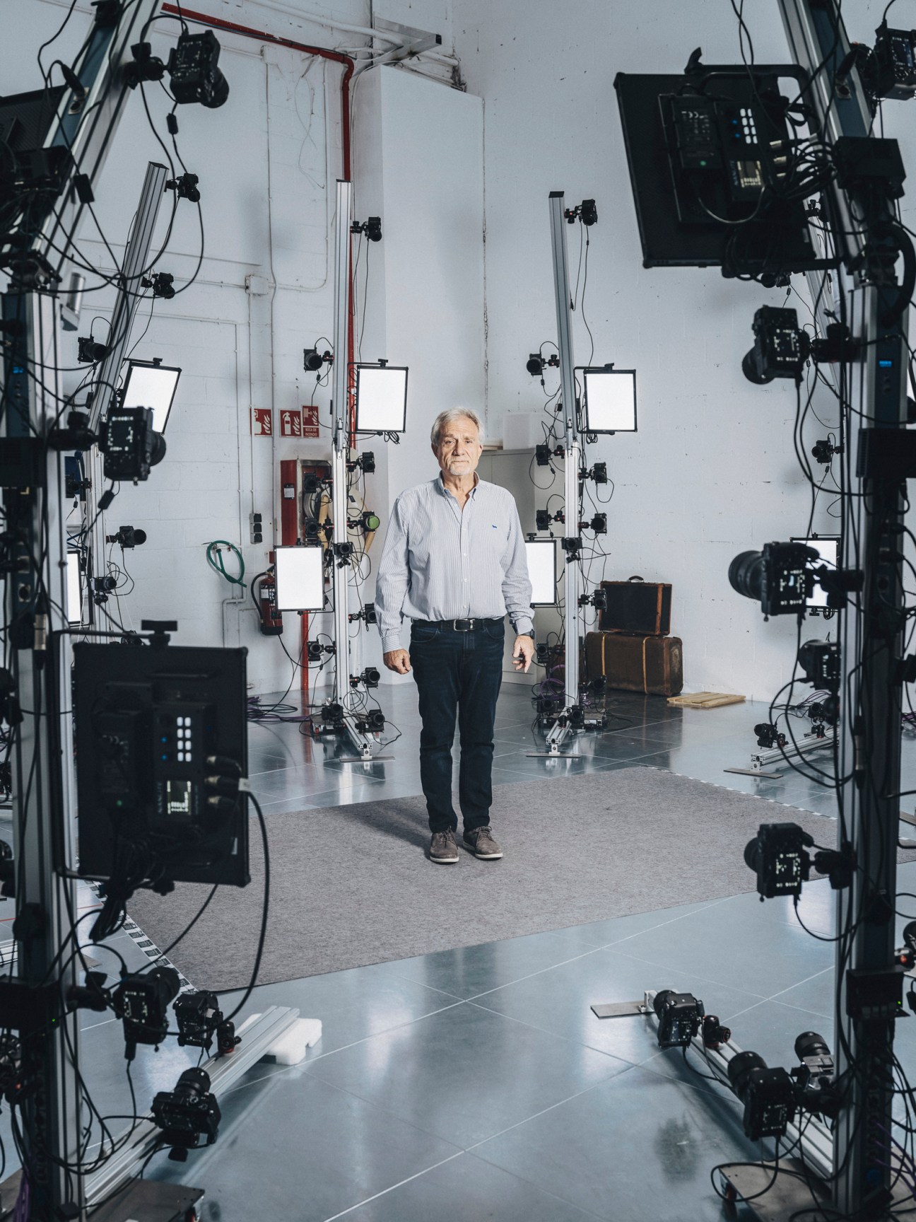 CEO Javier Toledo standing in a high-tech studio surrounded by cameras, lighting equipment and 3D scanning technology