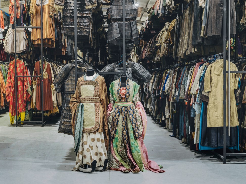 Traditional Chinese hanfu dresses hanging on display racks used in Disney's Mulan production