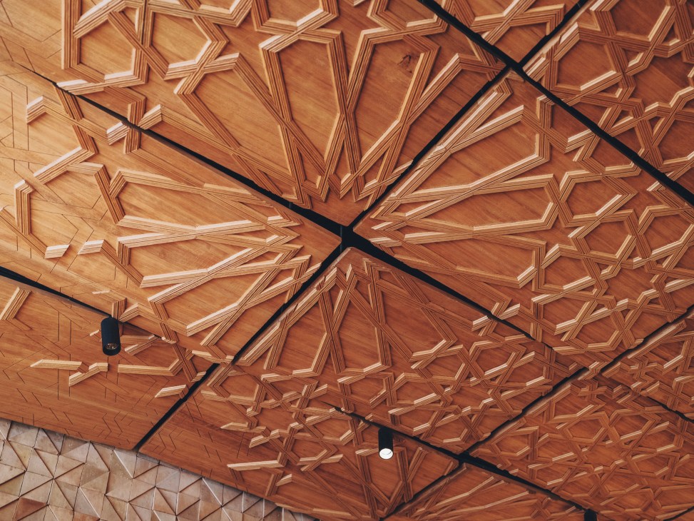 Detailed view of ornate traditional Moroccan ceiling with intricate geometric patterns and carvings
