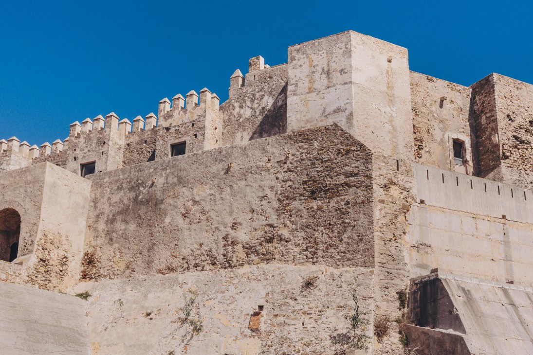 Castillo de Guzmán el Bueno, a medieval fortress with crenellated walls and towers in Tarifa, Spain.