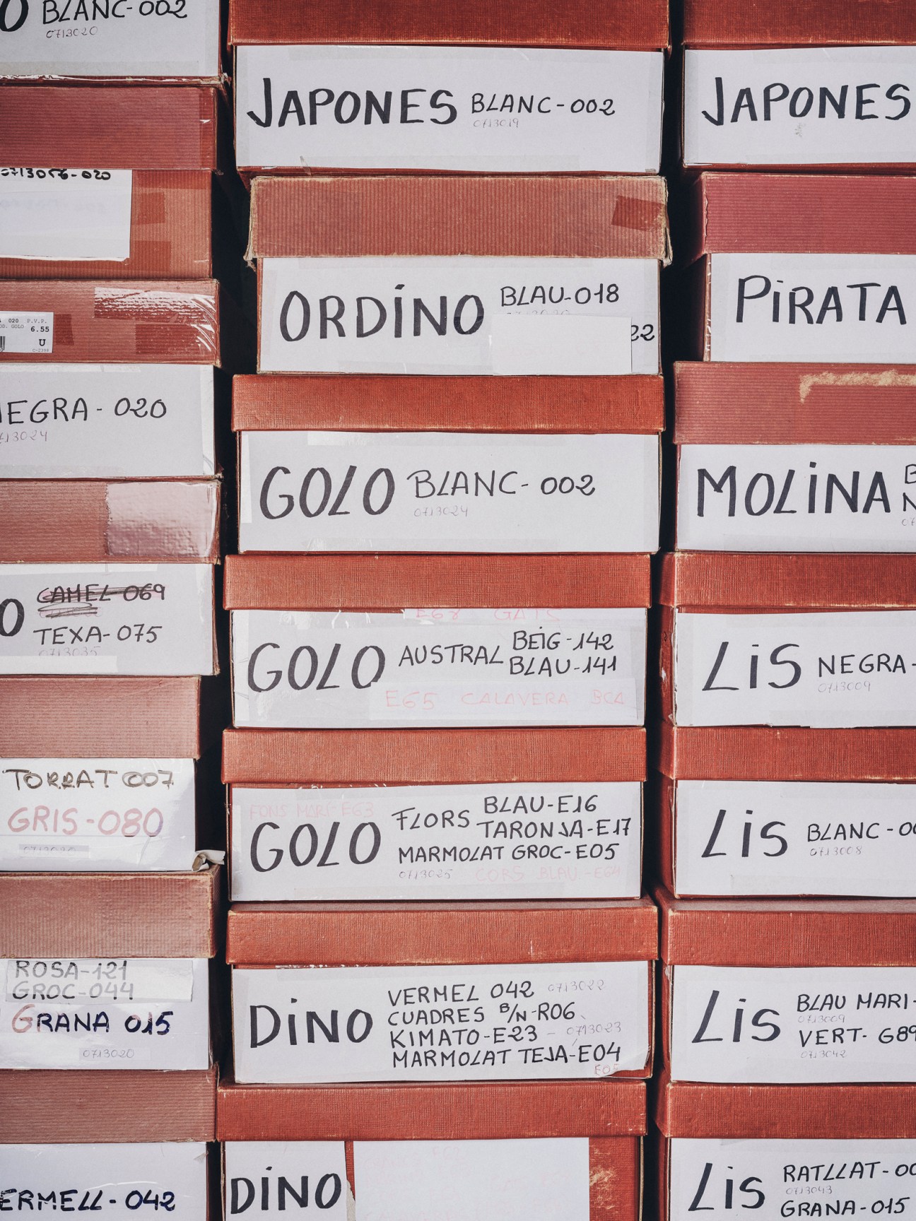 Organized display of sewing supplies including spools of thread and haberdashery materials in traditional shop