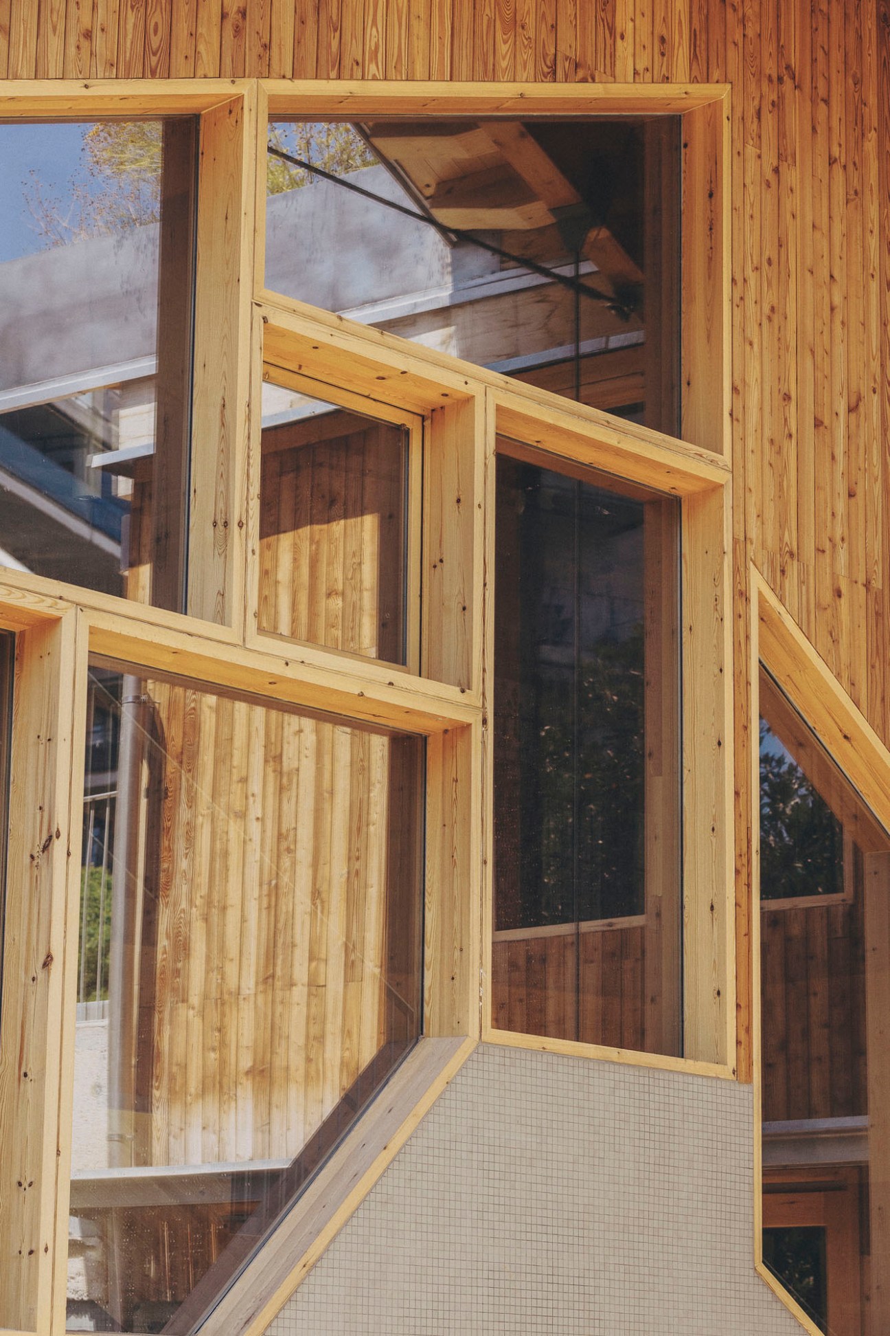 Exterior view of Imagine Montessori School showing wooden frame construction and large windows