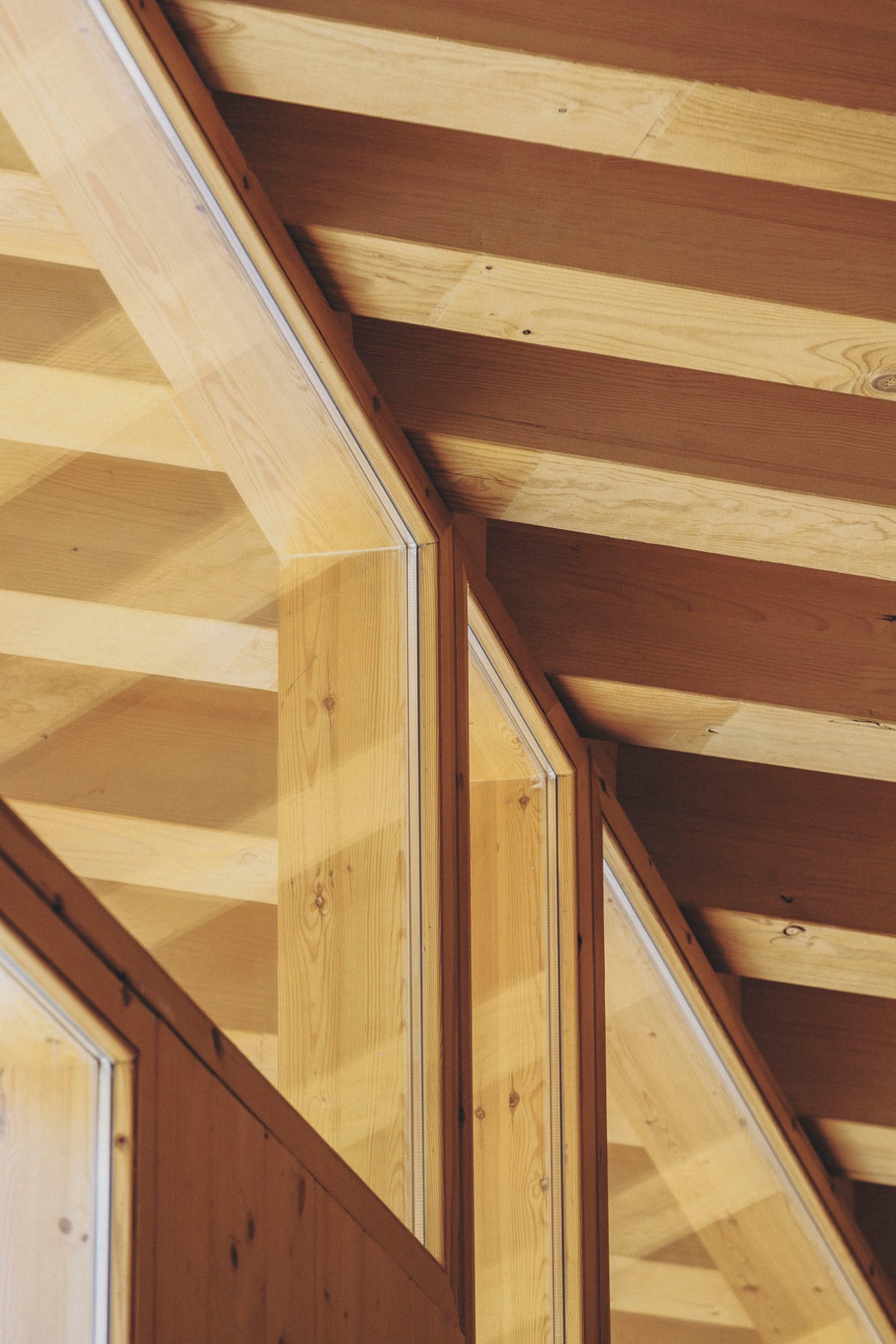 Close-up view of exposed wooden ceiling beams and structural elements at Imagine Montessori School