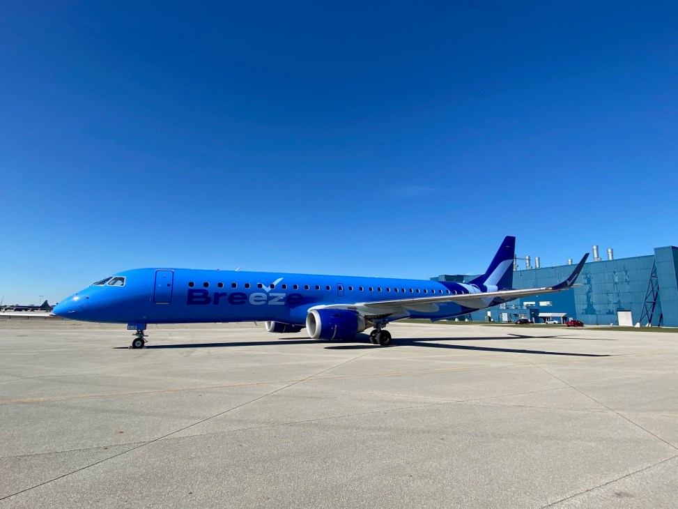 Blue Breeze Airways aircraft on airport tarmac under clear blue sky