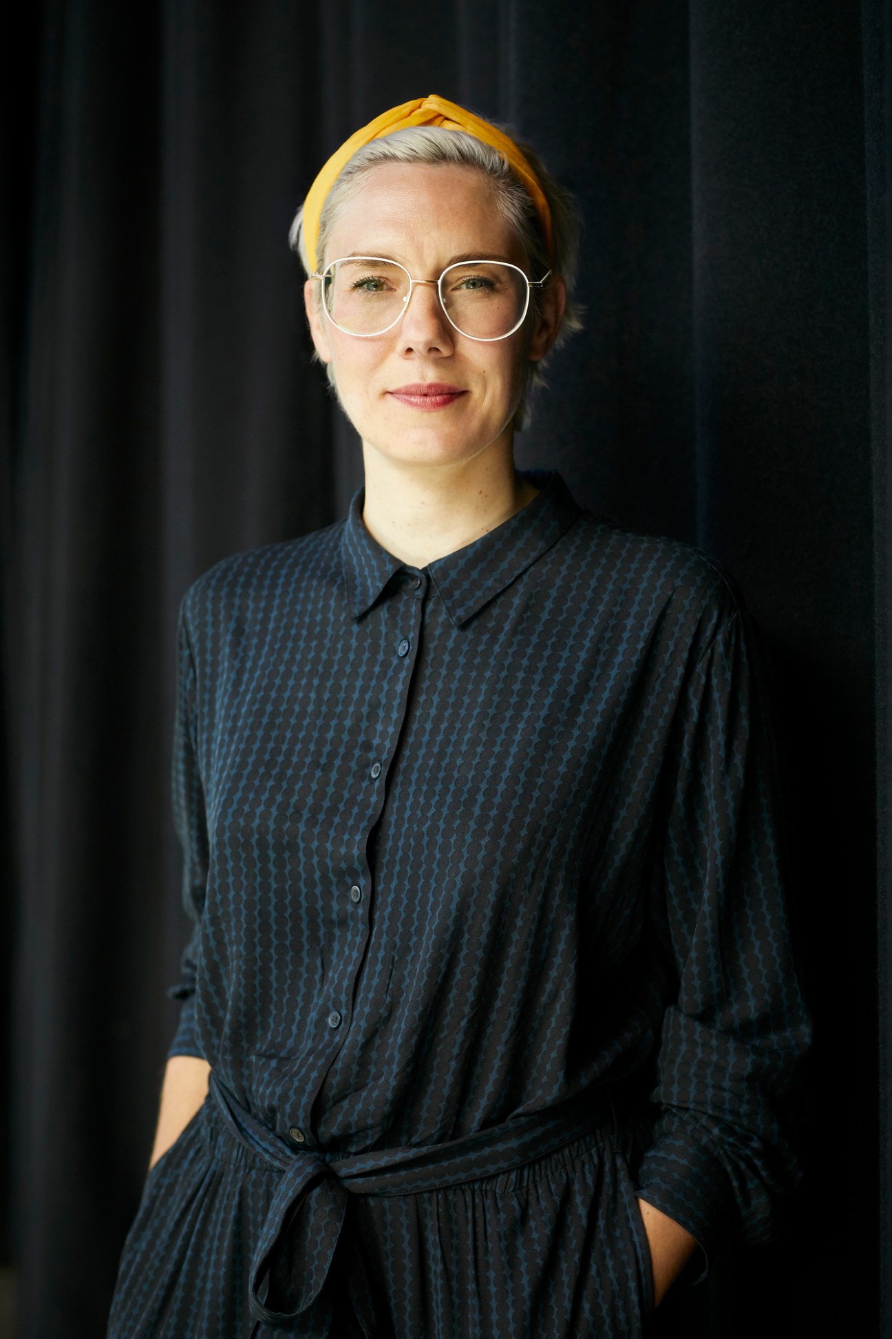 Portrait of Miriam Kathrein in professional attire against a modern interior