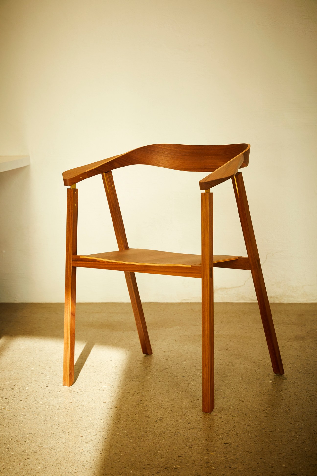 Minimalist wooden chair with curved backrest and clean lines showcasing Austrian craftsmanship