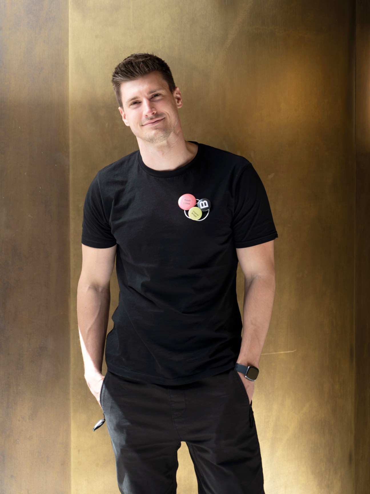 David Böhler, Bridge's project manager, wearing a black t-shirt and standing casually with hands in pockets