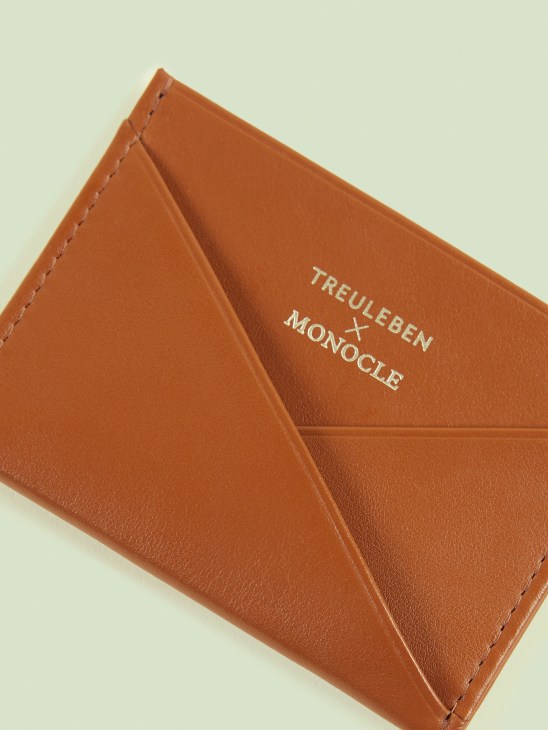 Treuleben × Monocle credit card caddy in tan leather with embossed branding.