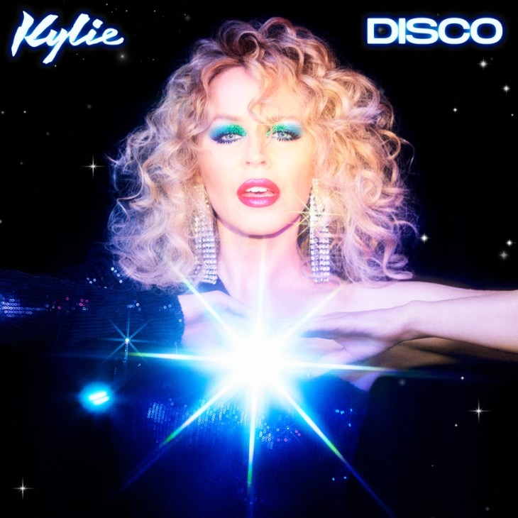 Album cover for Disco by Kylie Minogue featuring the artist with blonde curly hair and glittery makeup against starry background