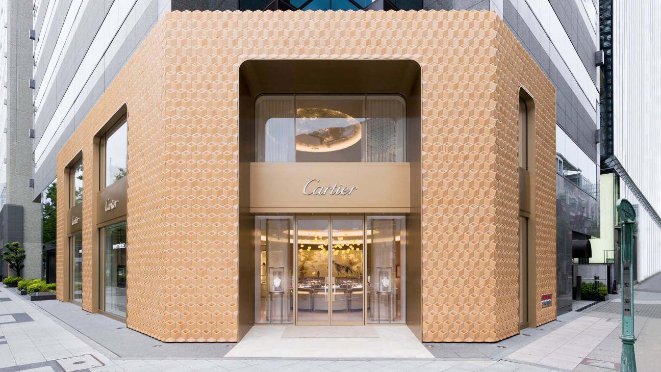 Exterior view of Cartier Shinsaibashi boutique featuring hinoki cypress wood facade with geometric pattern
