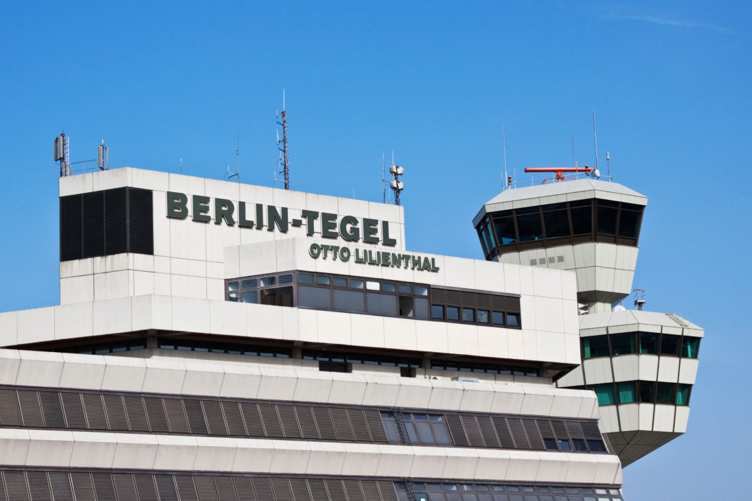 Berlin Tegel Airport terminal building with control tower against blue sky