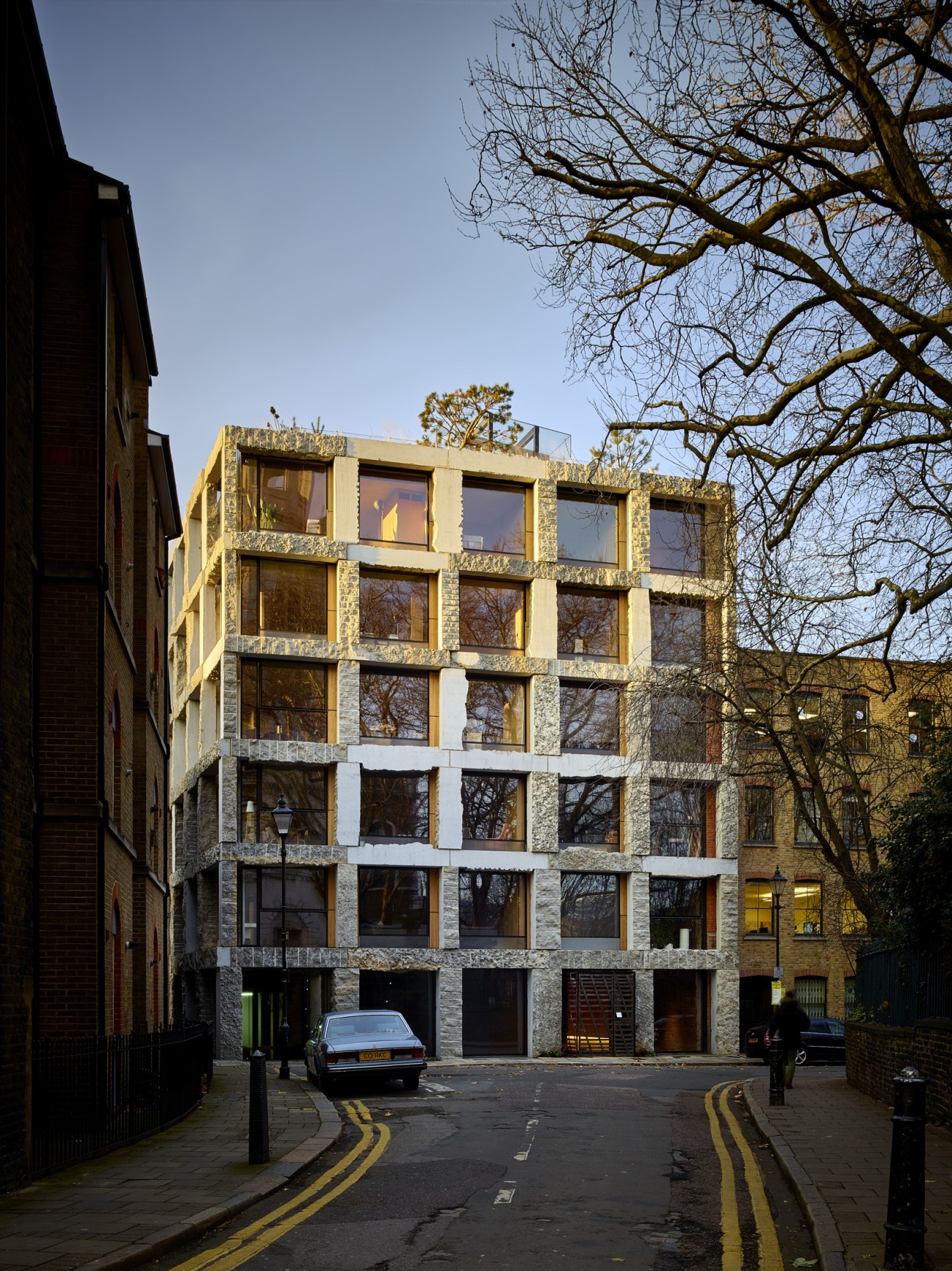 15 Clerkenwell Close, a modern six-storey stone and concrete building with large grid windows designed by architect Amin Taha.