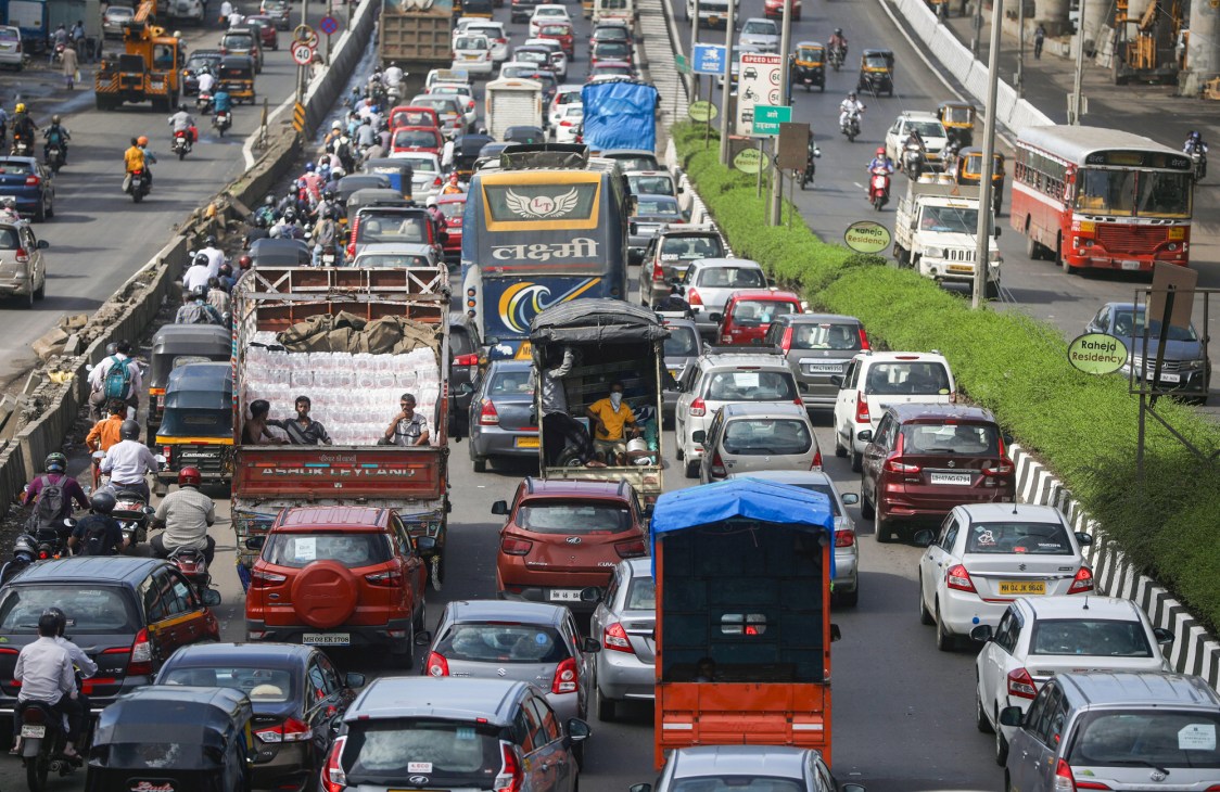 Heavy traffic congestion with cars, buses, motorcycles and auto-rickshaws on a busy multi-lane road