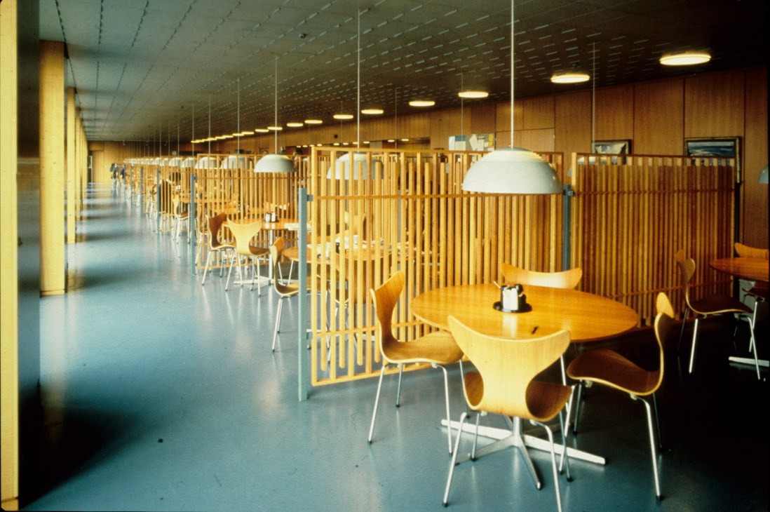 Interior of National Bank in Copenhagen featuring wooden slat dividers and pendant lighting in a modernist office space.