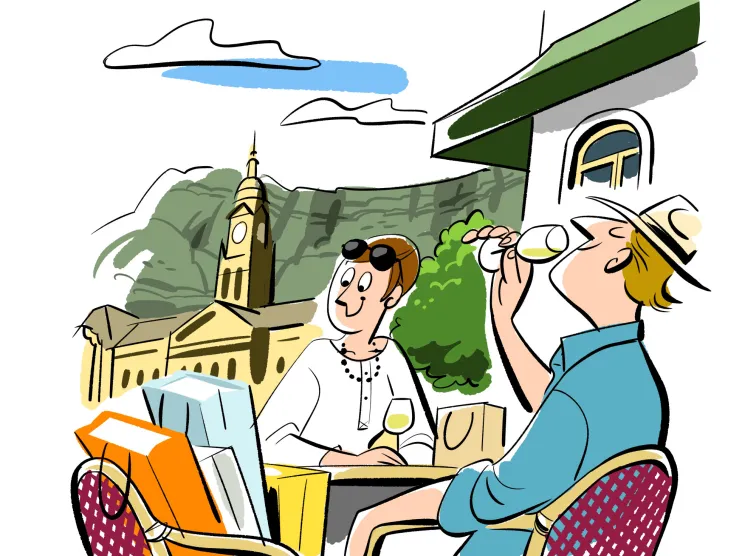 Two tourists dining outdoors with Table Mountain and Cape Town architecture in background
