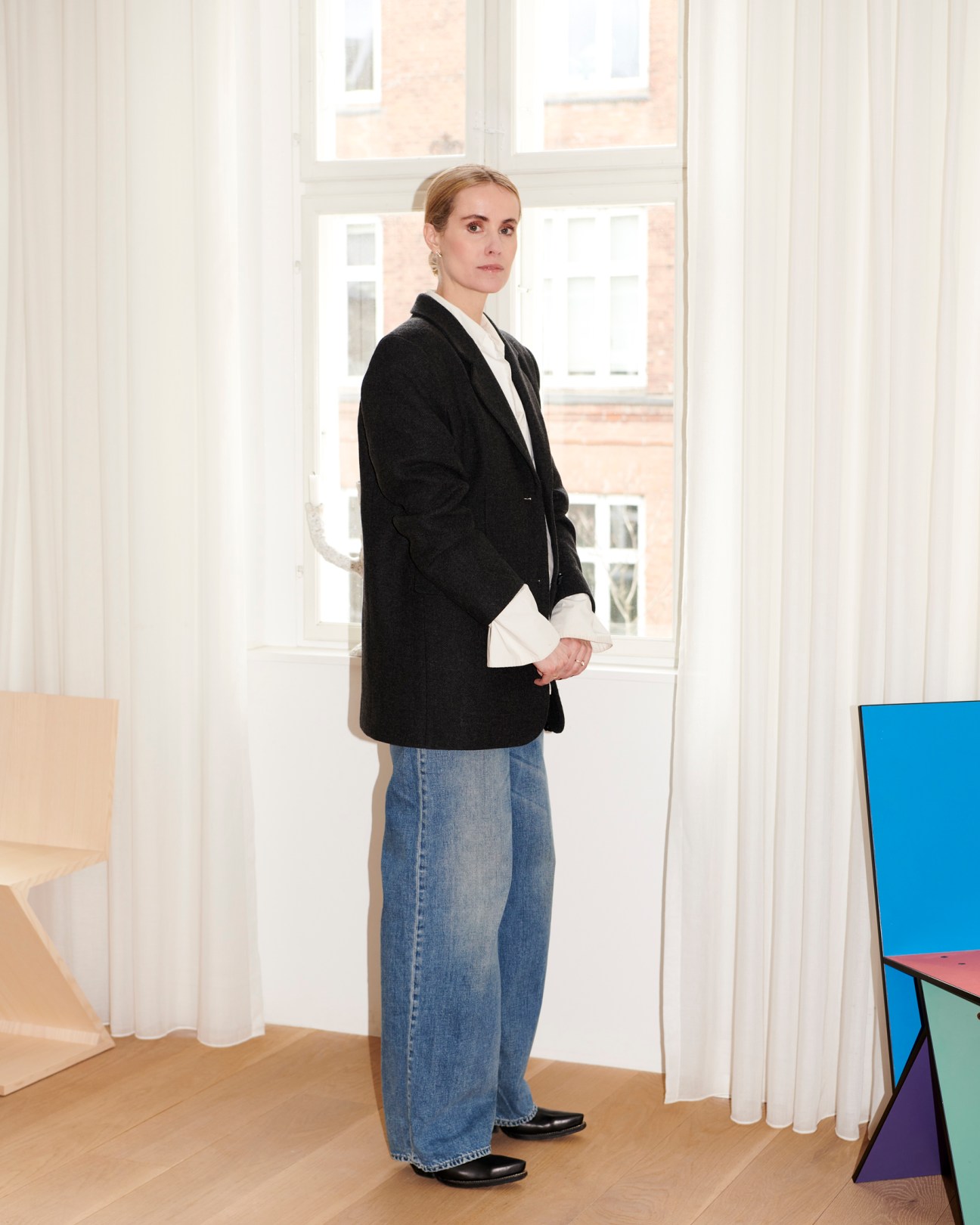 Cecilie Thorsmark, CEO of Copenhagen Fashion Week, wearing black blazer and jeans in bright modern interior