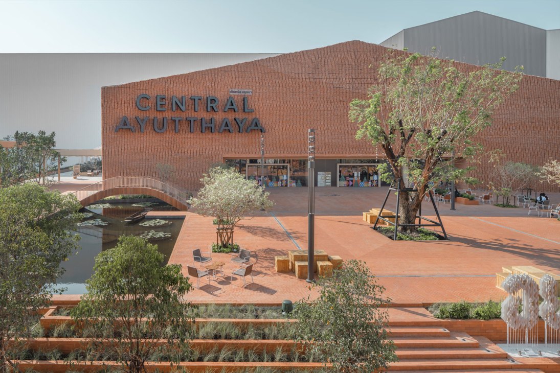 Central Ayutthaya shopping centre exterior with orange brick façade, public plaza, water feature and landscaping.