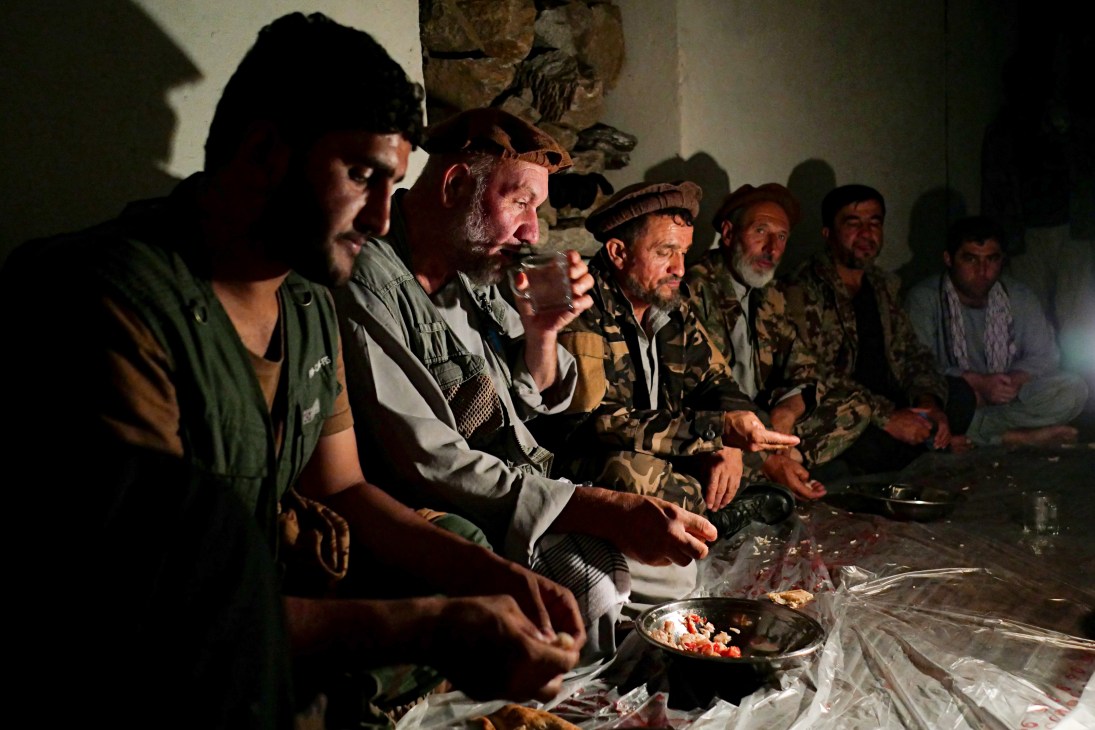 Resistance fighters of various ages sharing a meal together in the Panjshir Valley.