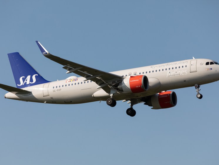SAS Scandinavian Airlines aircraft in flight against clear blue sky