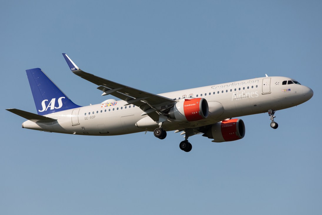 SAS Scandinavian Airlines aircraft in flight against clear blue sky