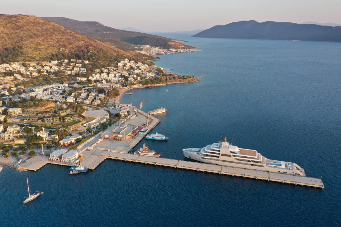 Aerial view of Bodrum marina with luxury yachts and superyachts moored alongside traditional Turkish coastal architecture
