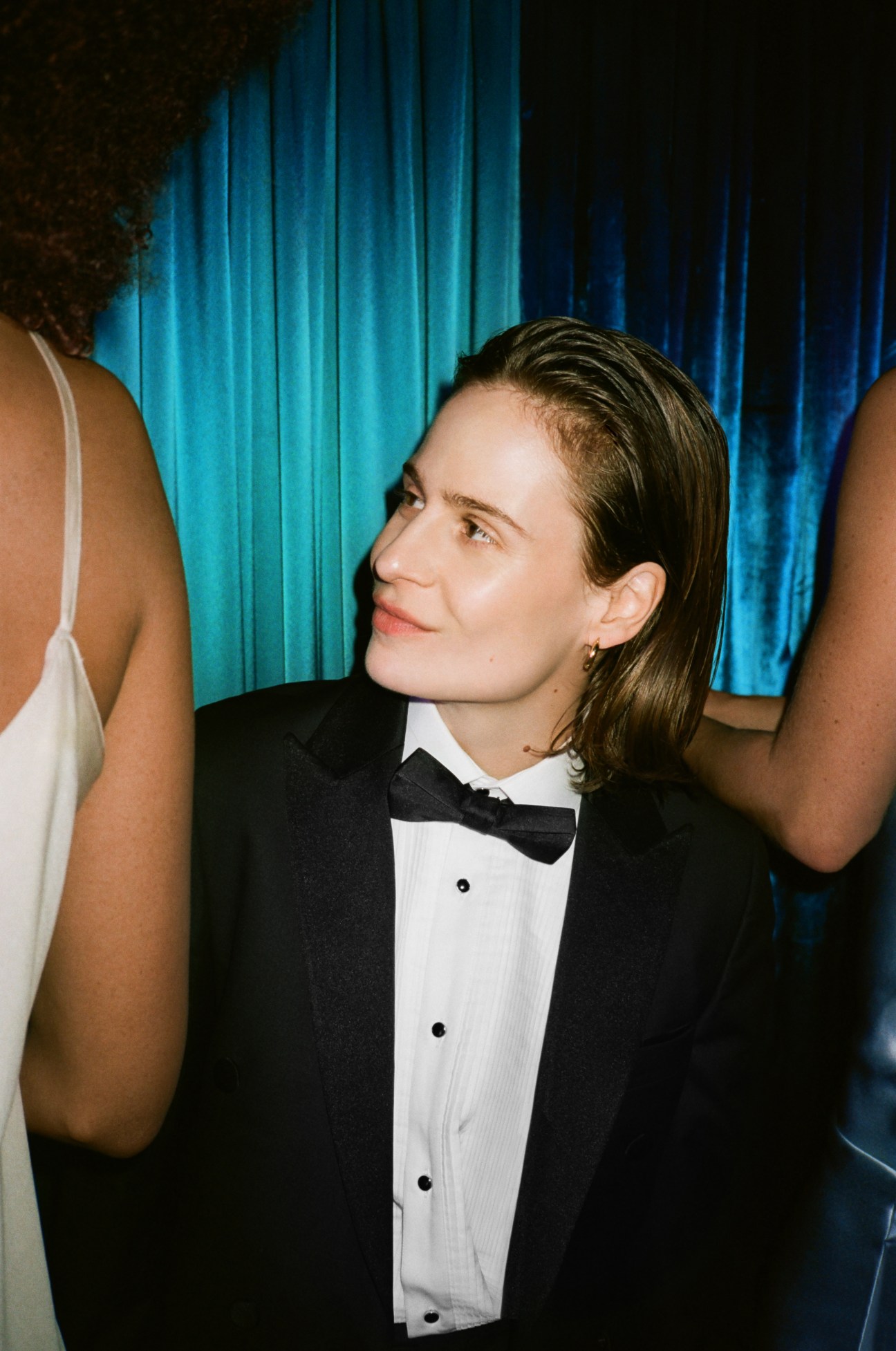 Christine and the Queens performer in formal black tuxedo with bow tie at evening event