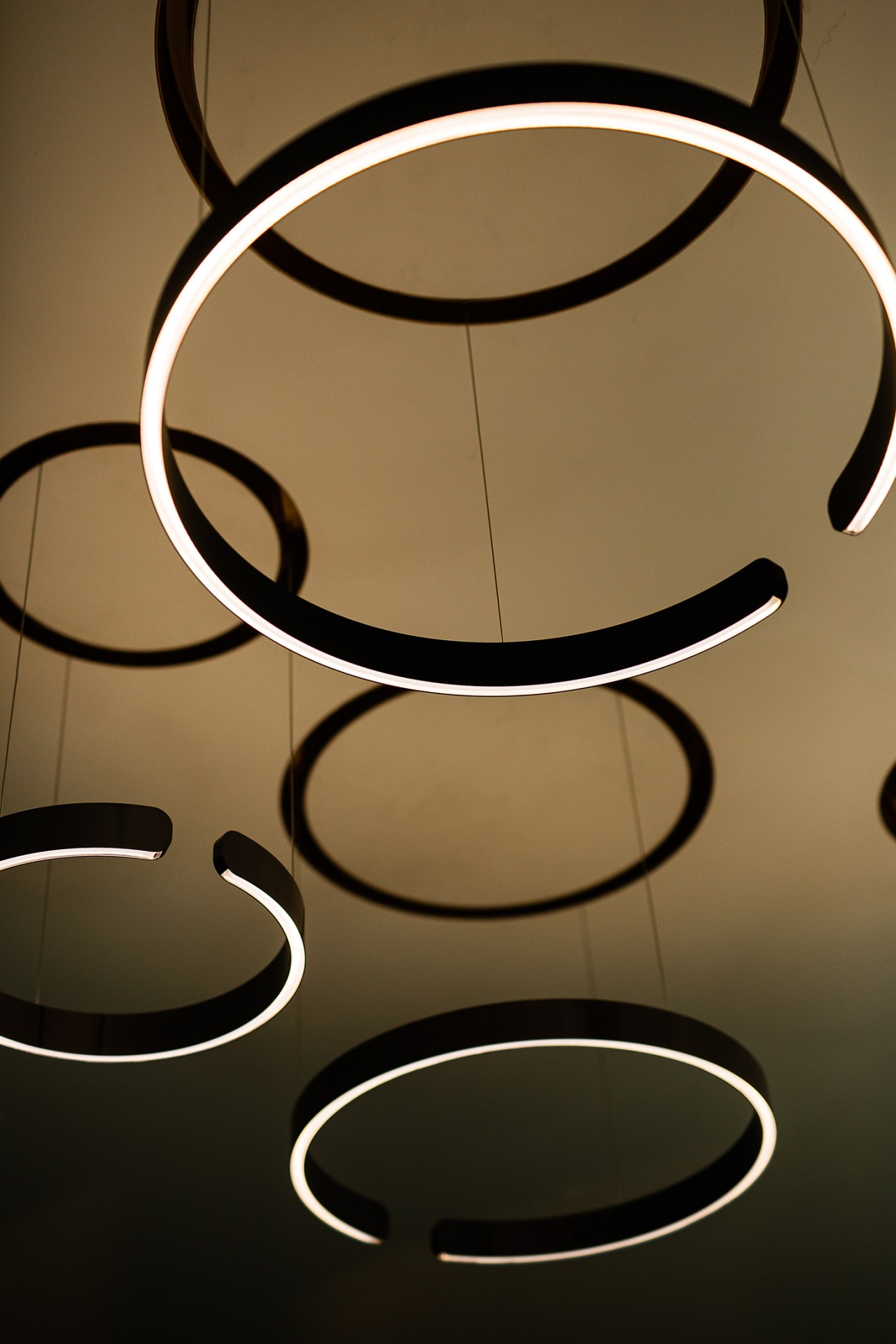 Multiple circular Mito light fixtures suspended from ceiling creating ambient illumination