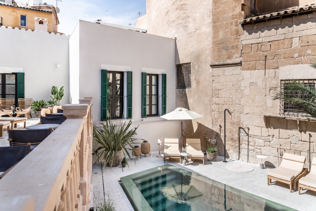 Rooftop pool area at Concepció by Nobis hotel in Palma with modern lounge furniture and Mediterranean architecture