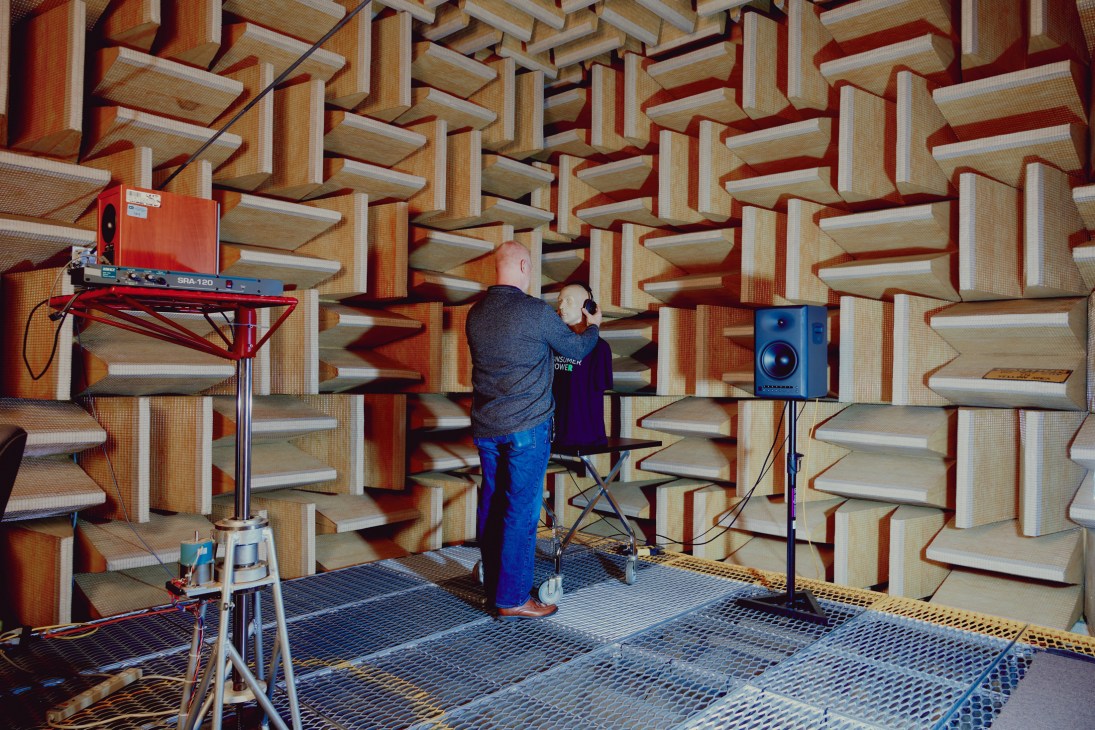 Anechoic chamber with foam acoustic panels covering walls and ceiling in geometric triangular pattern