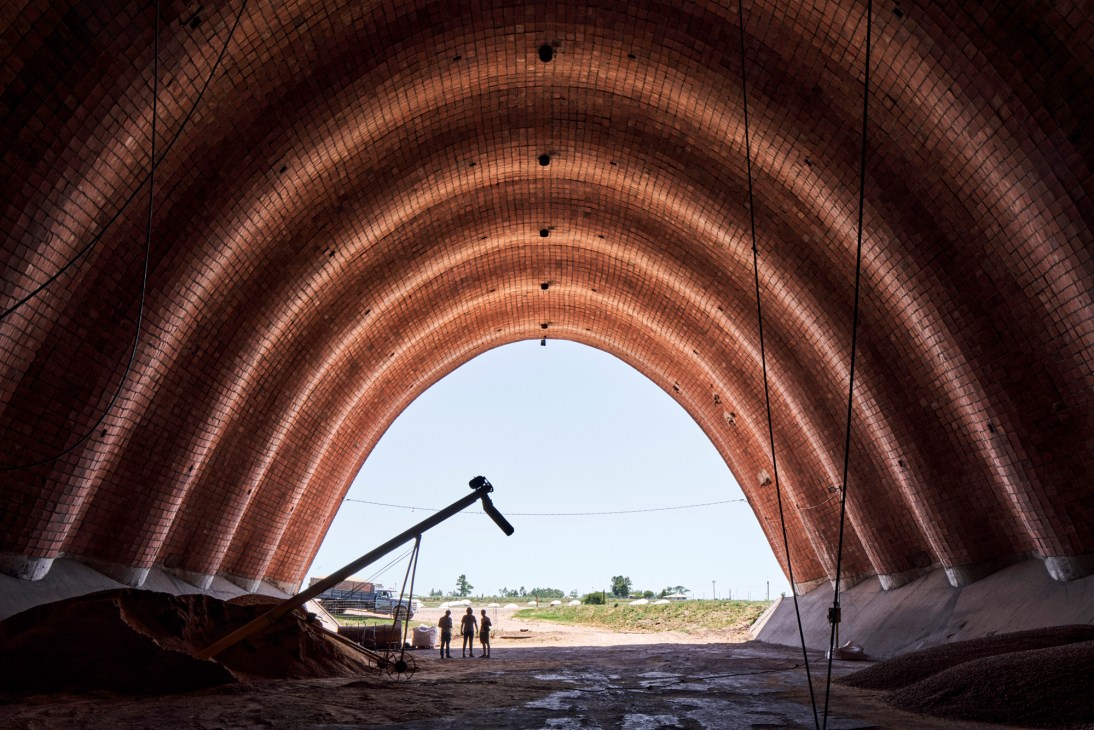 Interior view showing dramatic curved brick vaulted ceiling with natural light