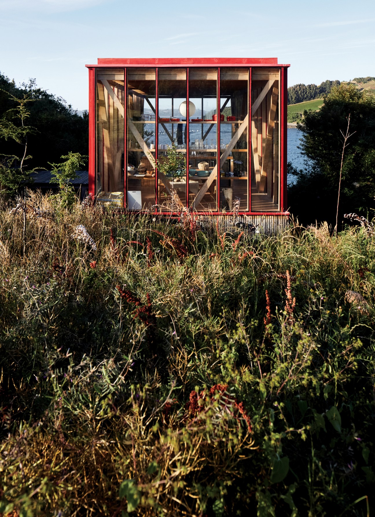 Roberto Pons's red-painted cabin on stilts, similar in design to Acuña's but slightly larger