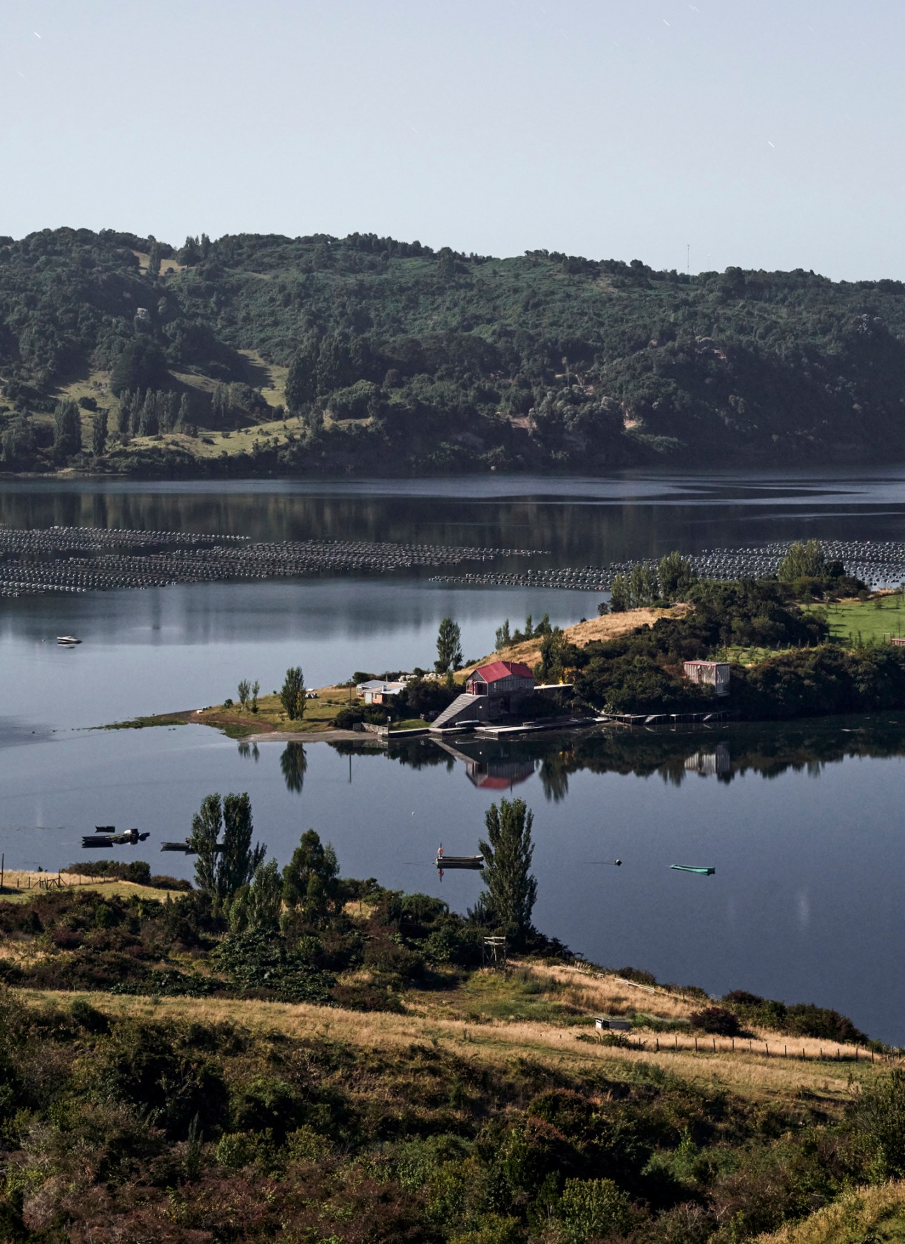 Aerial view of Chiloé archipelago during high tide showing water surrounding forested islands