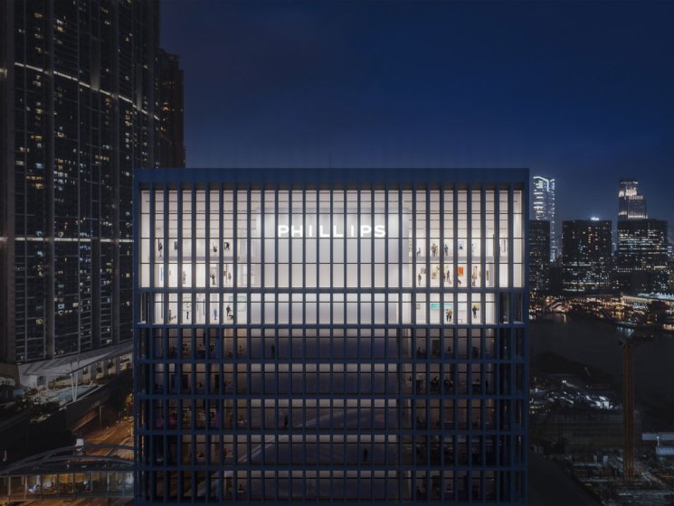 Modern glass office building illuminated at night in urban skyline