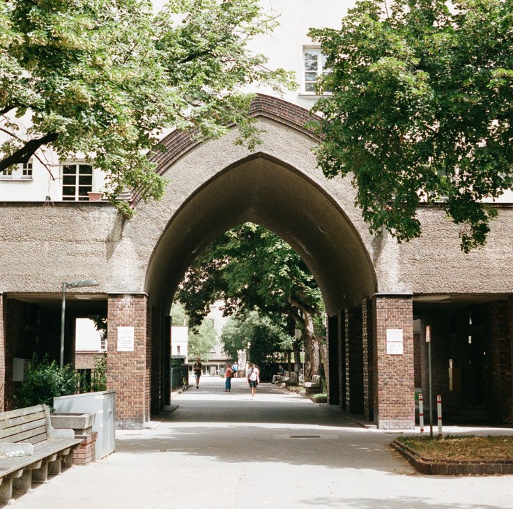 Arched passageway with brick construction connecting apartment buildings in a courtyard setting