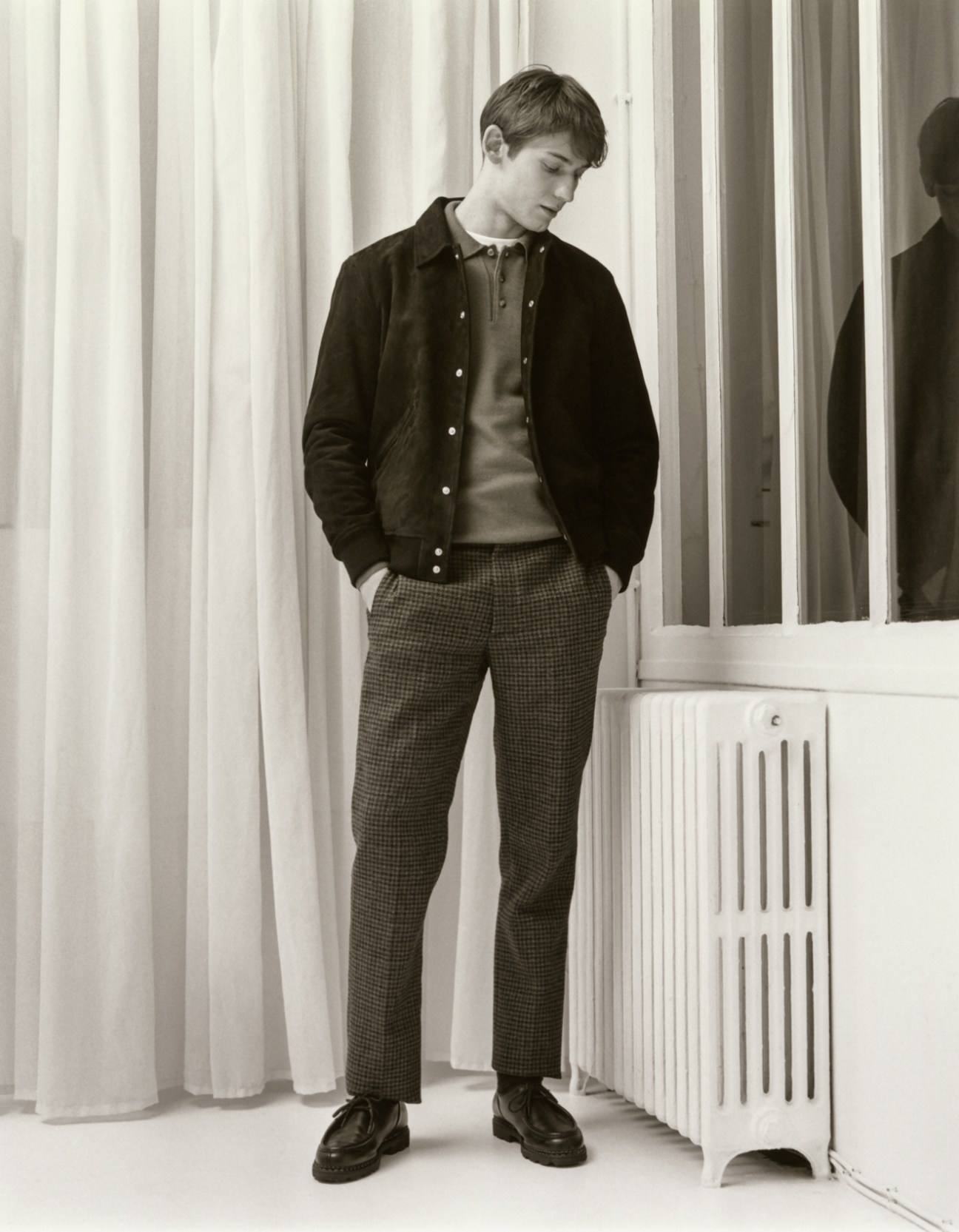 Model wearing jacket by Valstar, jumper by Arket, t-shirt by Uniqlo, trousers by Tod's, socks by Falke, and shoes by Paraboot
