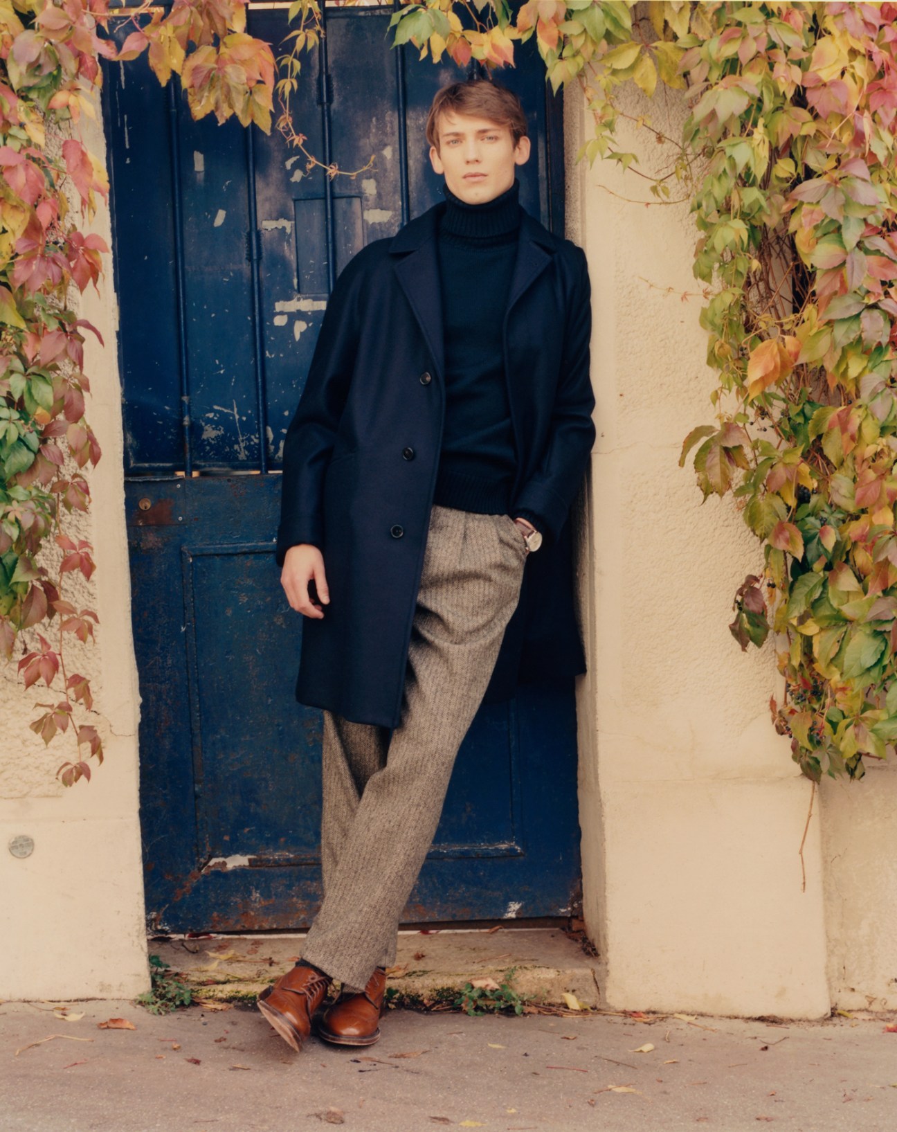 Model wearing coat by Cohérence at Beige Habilleur, jumper by Paul & Shark, trousers by De Bonne Facture, socks by Falke, shoes by Church's, and watch by Tag Heuer
