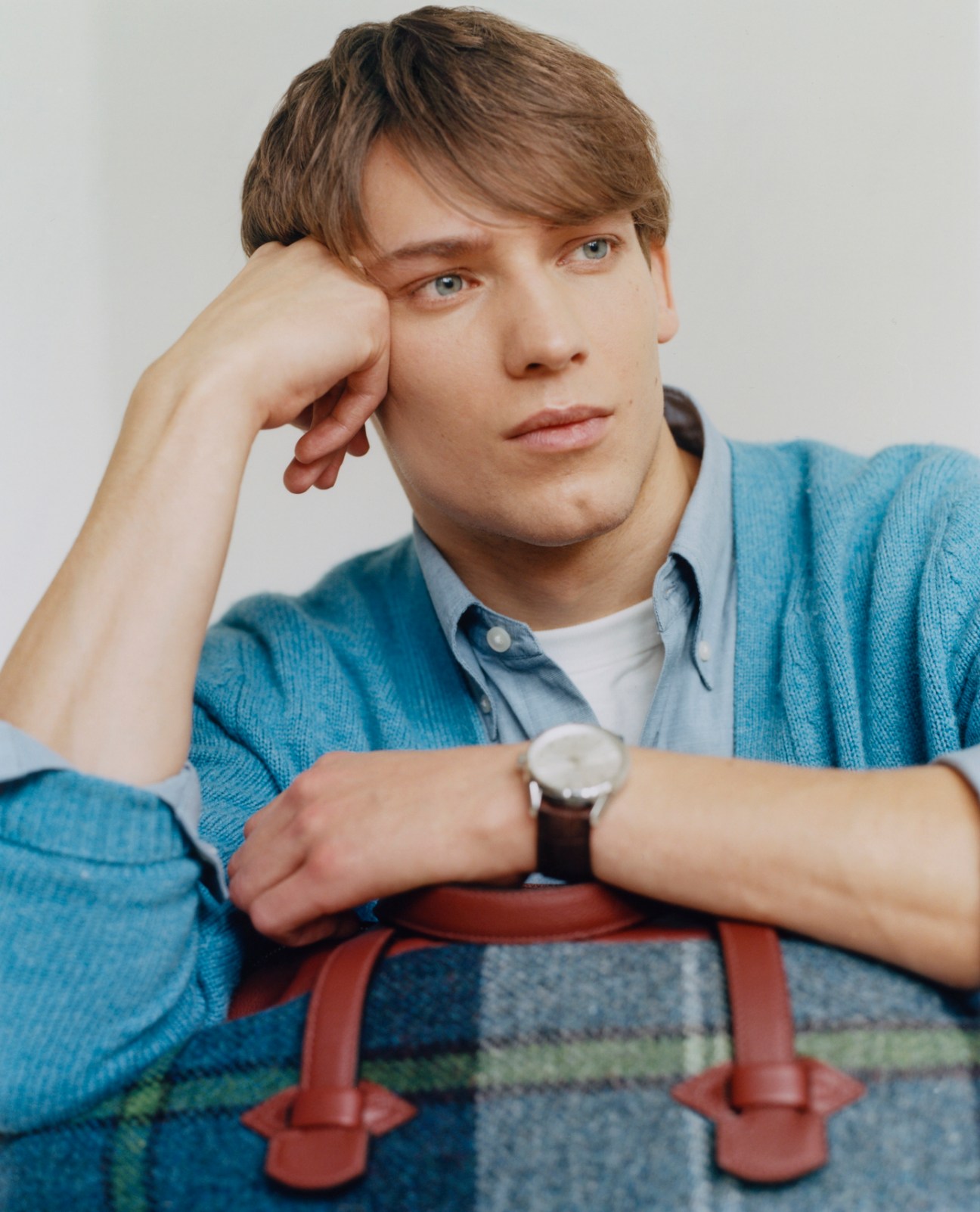 Model wearing jumper by Fursac, shirt and t-shirt by Uniqlo, with bag by Hermès and watch by Tag Heuer
